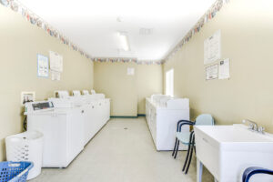 Interior Laundry Facilities, 5 Washers 5 dryers, Utility sink, Waiting Chairs.